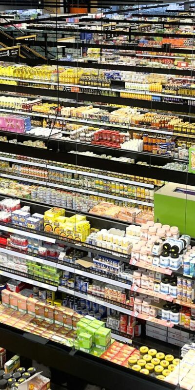 Aerial view of supermarket aisles filled with colorful products and packaging.