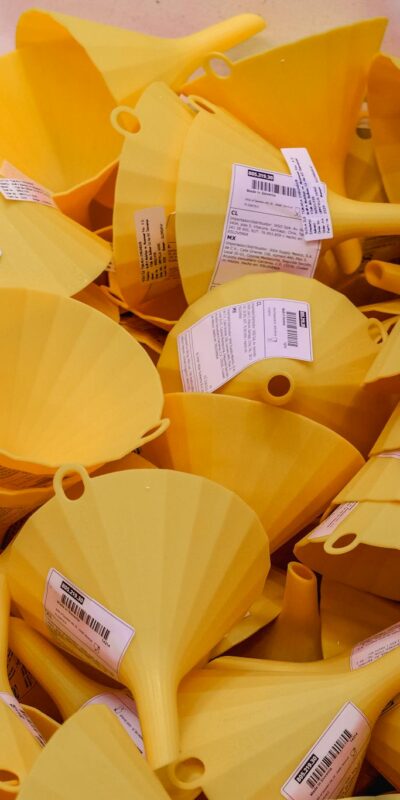 Photo by Crab Lens Close-up of a pile of yellow plastic funnels for sale in an Istanbul market.